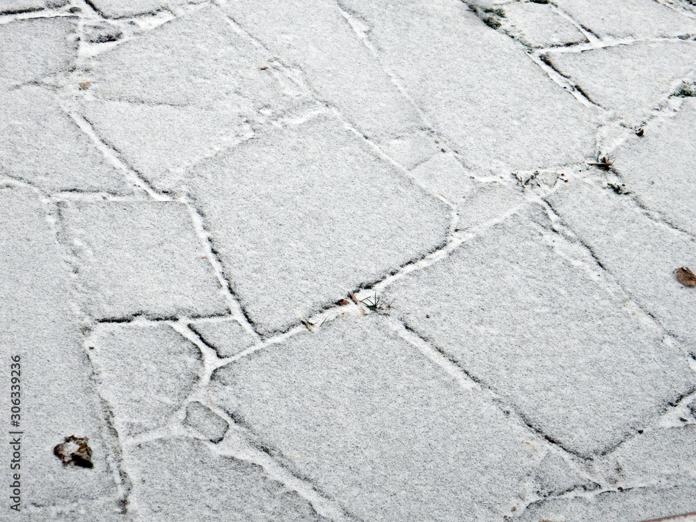 Obraz premium red stone paved with snow road and brick wall