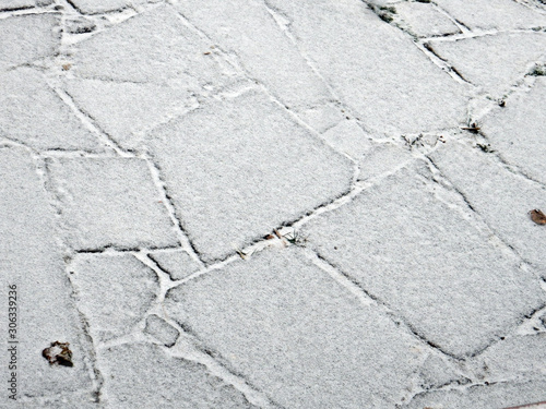 red stone paved with snow road and brick wall