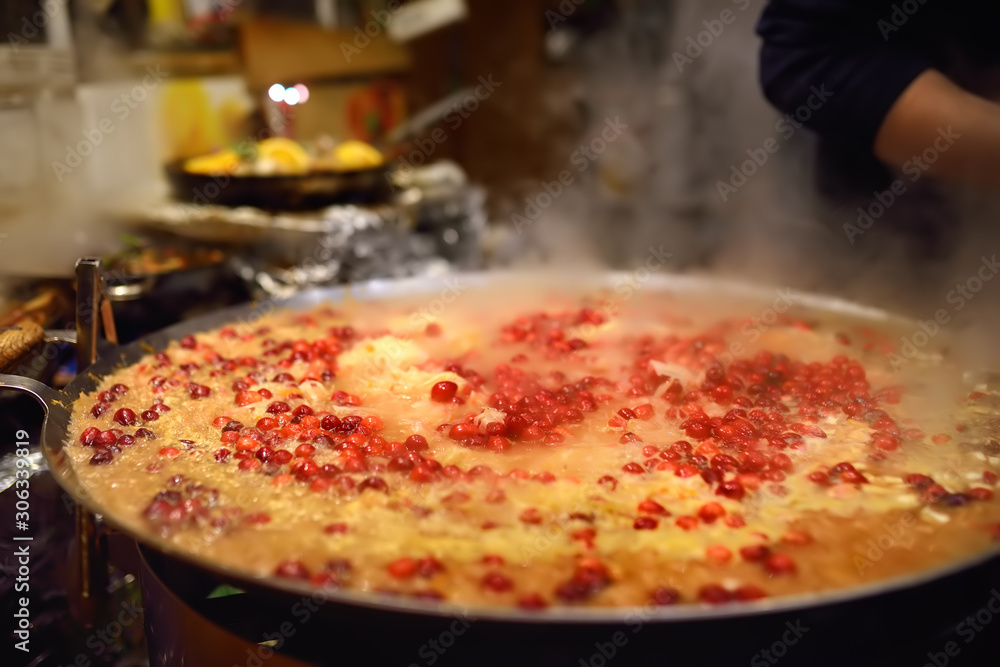 Hot food on Tallinn Christmas fair.Stewed cabbage with berry in frying pan.