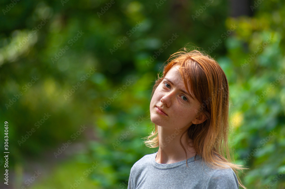 Sad redhead young naturally beautiful girl stays in simple summer outfit outdoor Sad redhead young naturally beautiful girl stays in simple summer outfit outdoor