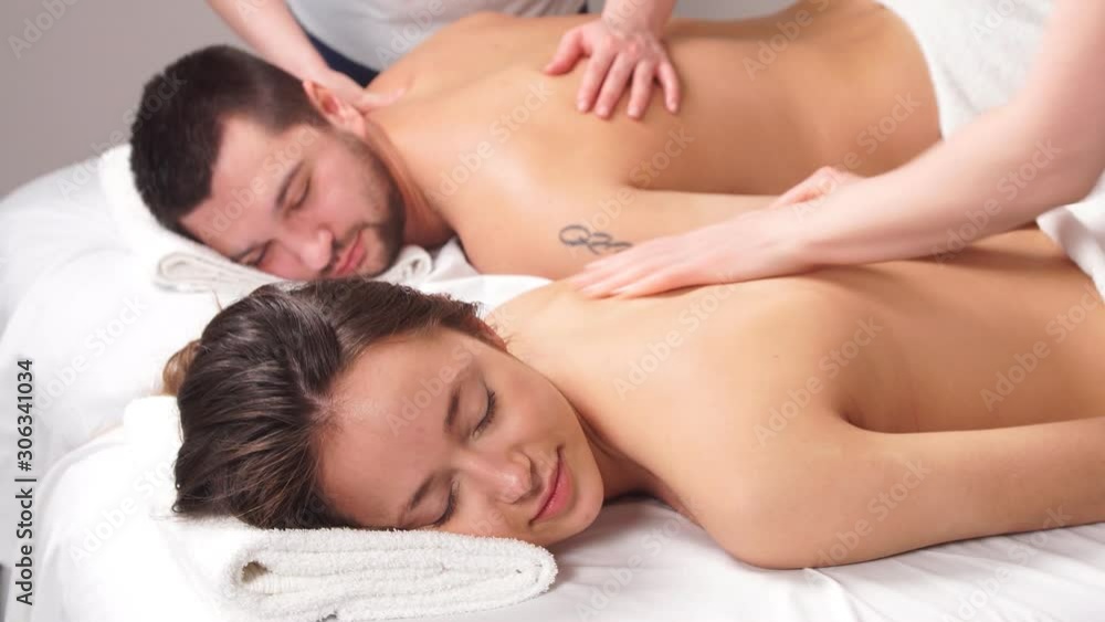 Beautiful couple enjoying relax massage in modern spa center. Beauty treatment concept Beautiful couple enjoying relax massage in modern spa center. Beauty treatment concept
