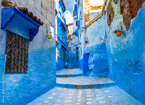 Typical street with blue walls in Moroccan city of Chefchaouen © leelook