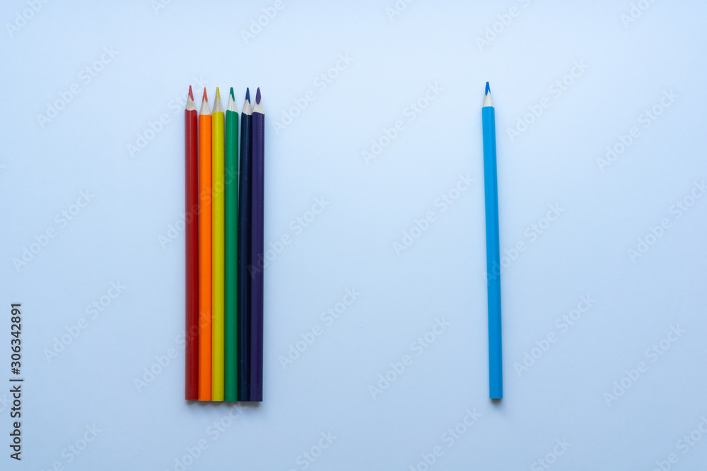 Set of six sharp rainbow-colored pencils except blue, from top view on a white background. Concept of creativity. Art supplies. Minimalism. Childhood. LGBT.