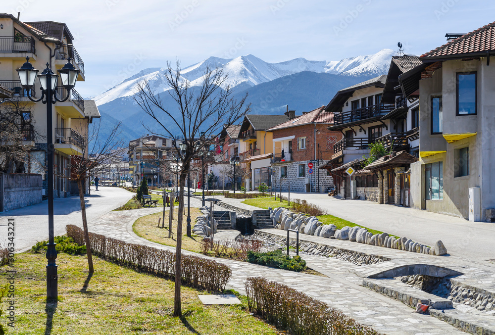 Gotse Delchev street and promenade in the mountain town of Bansko, now the largest mountain resort in Bulgaria. In the background the Pirin mountains Gotse Delchev street and promenade in the mountain town of Bansko, now the largest mountain resort in Bulgaria. In the background the Pirin mountains