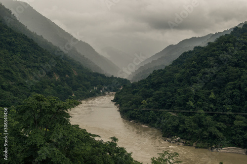 A view of the Ganges river, Mountains and clouds on a rainy day in Rishikesh, India