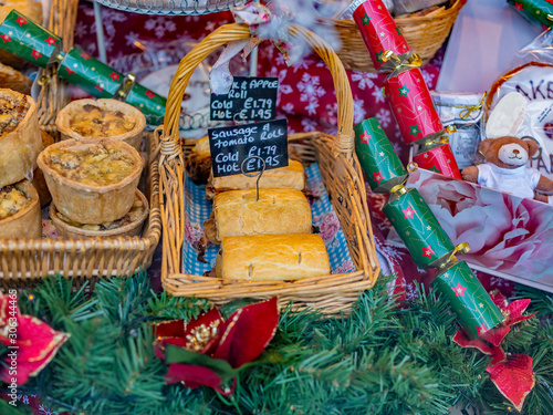  Baked Christmas special pies, pastries and foods on display and for sale in the window of a bakery