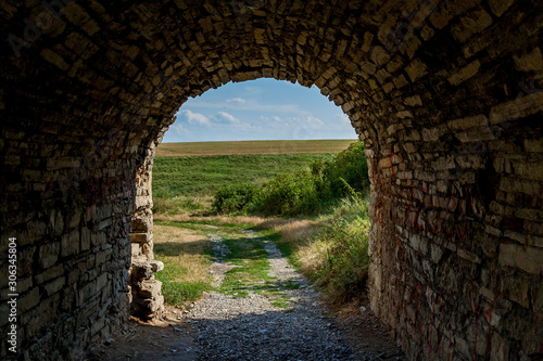 The old archway in the wall of the stone fortress in Kamianets-Podilskyi