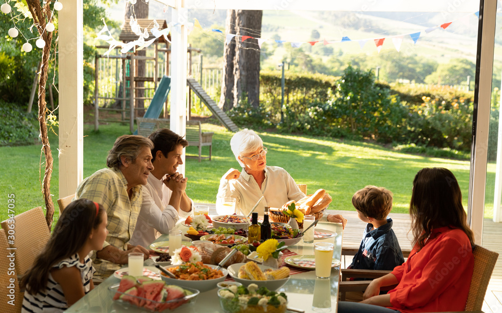 Naklejka premium Family eating outside together in summer