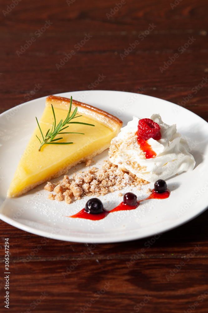 Fresh tasty lemon tart with crumble and whipped cream Fresh tasty lemon tart with crumble and whipped cream