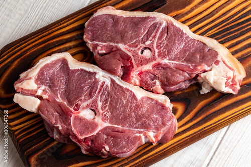 Raw lamb meat on a wooden cutting board