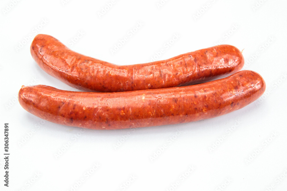 several raw merguez on a white background several raw merguez on a white background