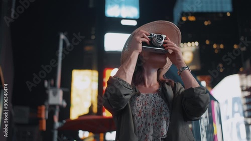 Smiling girl with a retro camera in Times Square, NYC