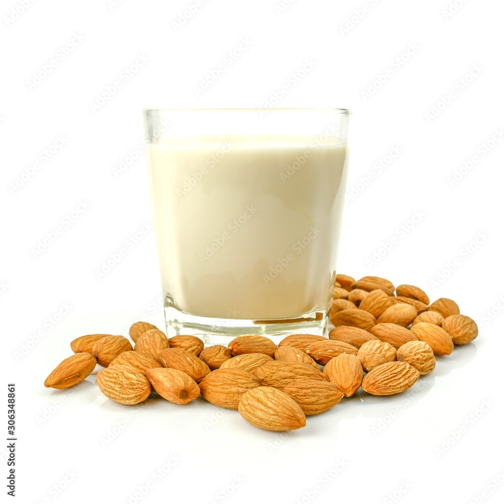 almond kernel and almond milk in the glass isolated on white background almond kernel and almond milk in the glass isolated on white background
