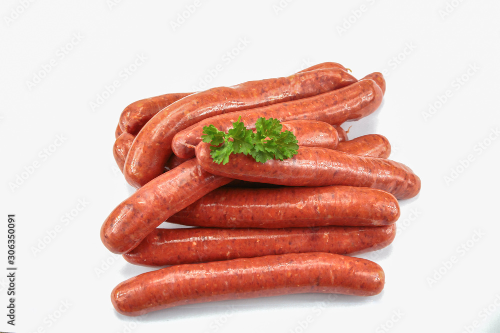 several raw merguez on a white background several raw merguez on a white background