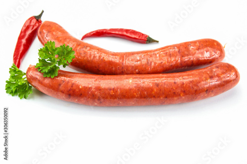 several raw merguez on a white background
