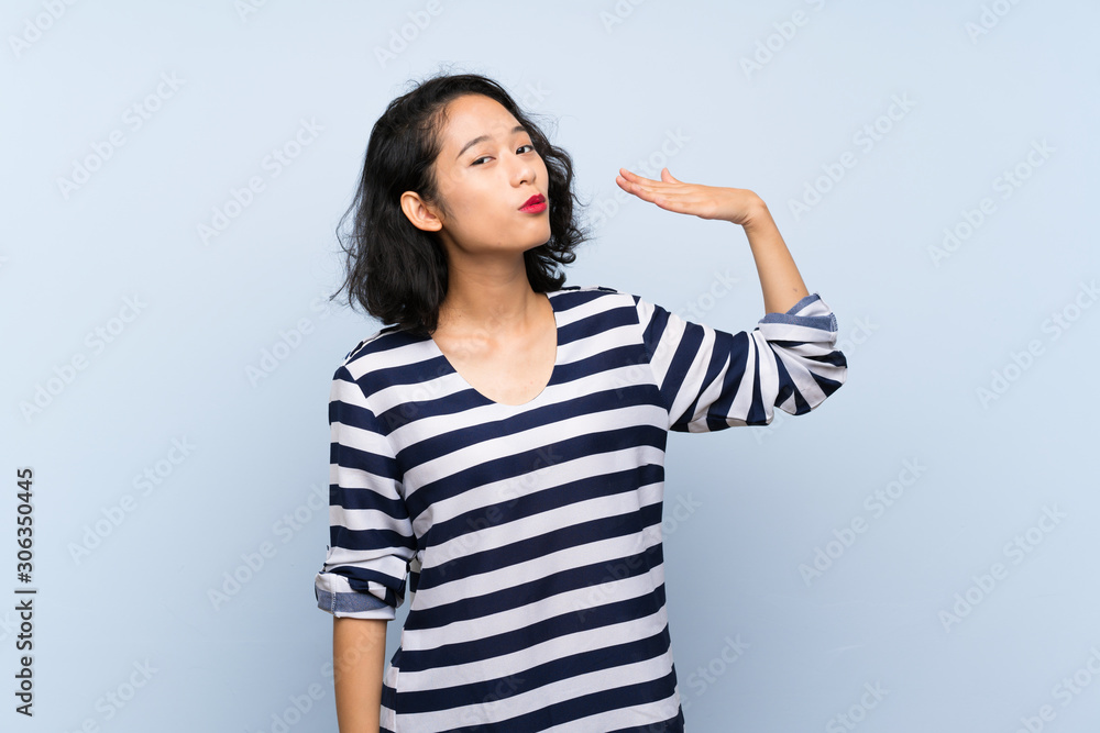 Asian young woman over isolated blue background with tired and sick expression Asian young woman over isolated blue background with tired and sick expression