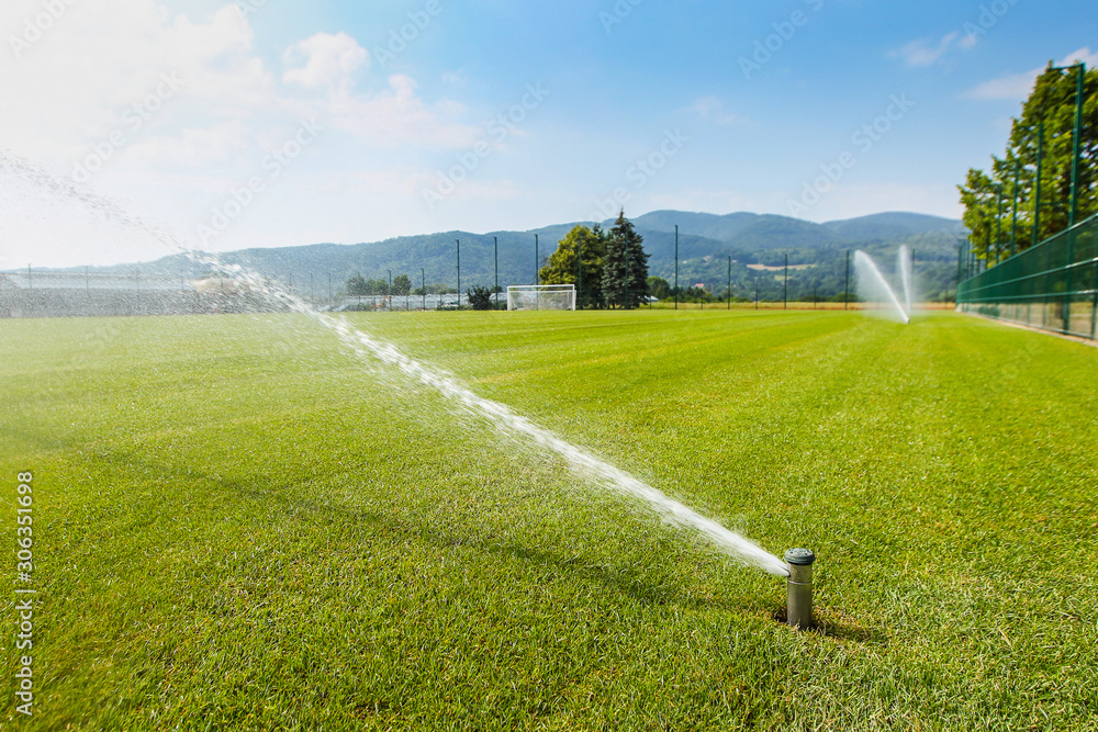 Sprinkler in a football field in full operation Stock Photo Adobe Stock
