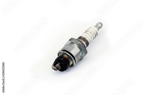 Worn and dirty spark plug of a car, isolated on white surface