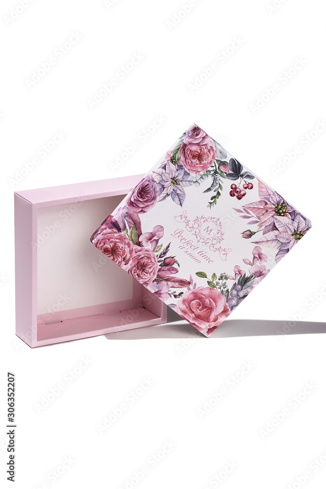 Subject shot of a white gift box with a white bottom and a lid decorated with colorful floral tropic print, design with letters and a pleasant text: Subject shot of a white gift box with a white bottom and a lid decorated with colorful floral tropic print, design with letters and a pleasant text: