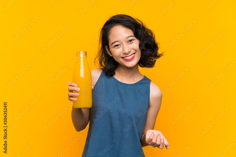 Asian young woman holding an orange juice Asian young woman holding an orange juice