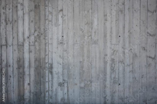 Concrete wall texture. Imprints of wooden boards used to make concrete wall are seen on concrete wall.