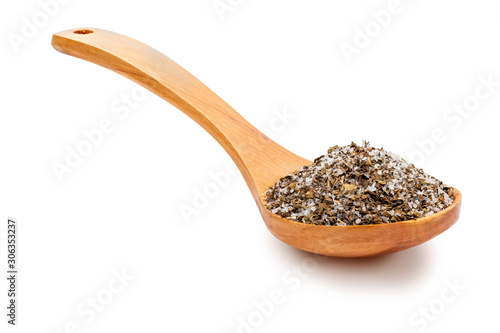 Fine and white salt with fine herbs, with various spices (rosemary, oregano and black pepper) in a wooden spoon (salt varieties collection). Isolated on white background Rustic appearance