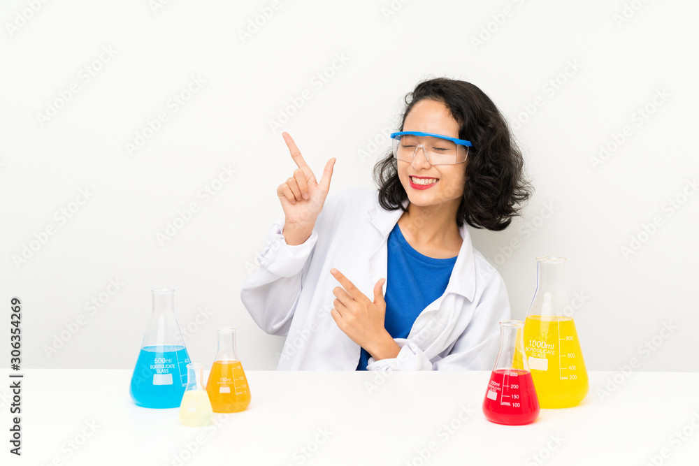 Young scientific asian girl pointing with the index finger a great idea Young scientific asian girl pointing with the index finger a great idea