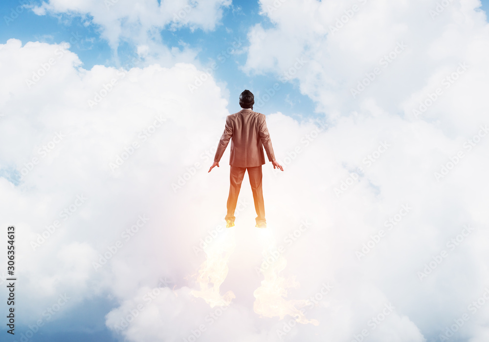 Businessman in suit and aviator hat flying in sky Businessman in suit and aviator hat flying in sky