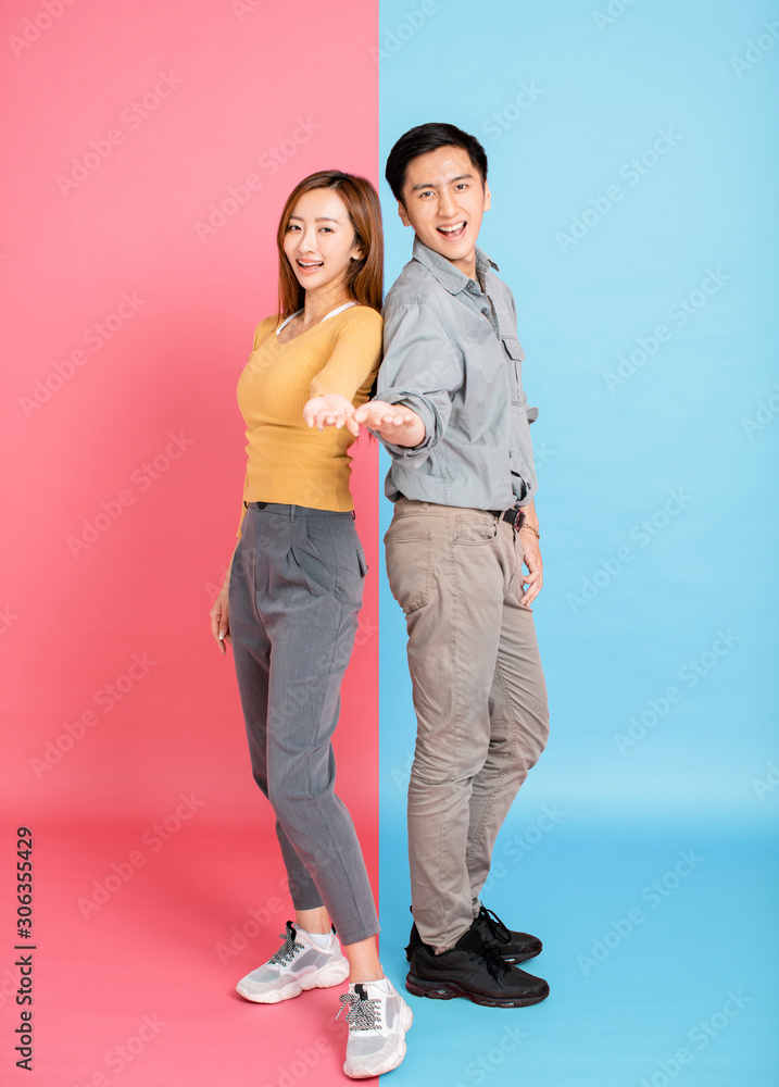 Fototapeta premium Portrait Of Happy Young Couple with showing gesture