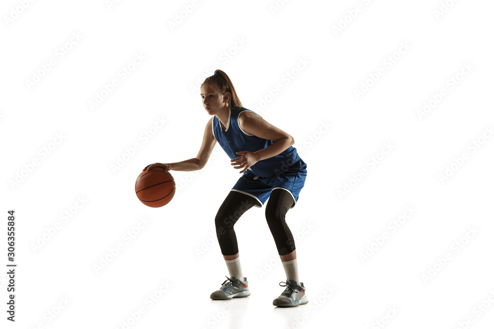 Young caucasian female basketball player of team in action, motion in run isolated on white background. Concept of sport, movement, energy and dynamic, healthy lifestyle. Training, practicing.