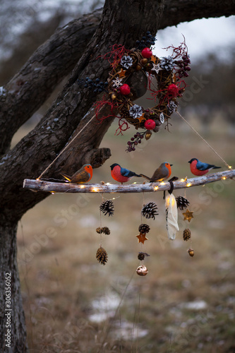 handmade christmas and new year decor with wooden birds and natural materials.creative home decor for winter holidays