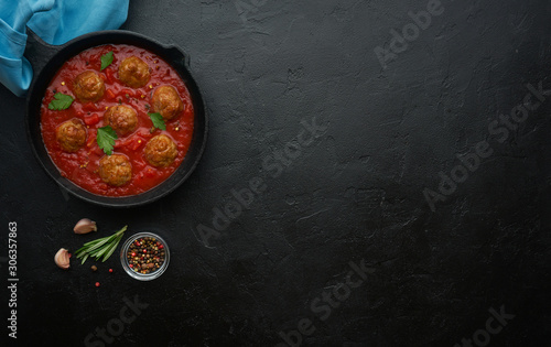 Pan with meat balls in tomato sauce. Flat lay, top view with copy space