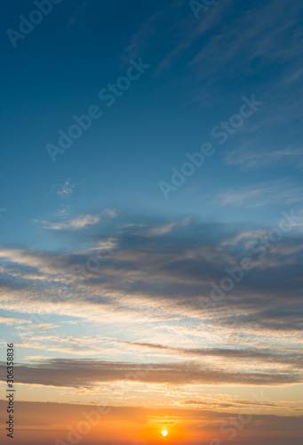 Fantastic clouds at sunrise  vertical panorama