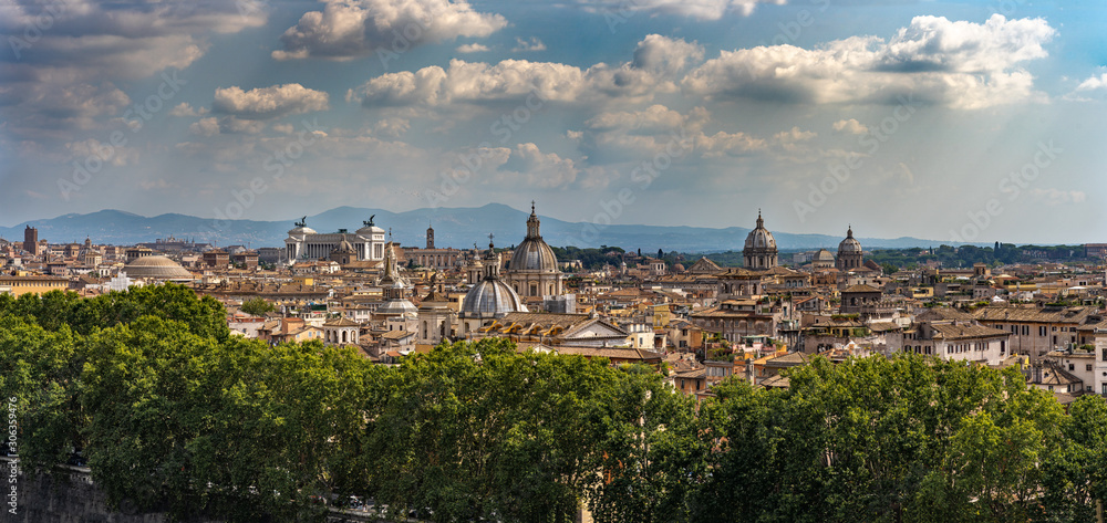 Beautiful panorama of Rome. Cityscape. View on the city of Rome from the Castle Sant'Angelo. Beautiful sunny weather with white clouds in Rome. Travel photo.