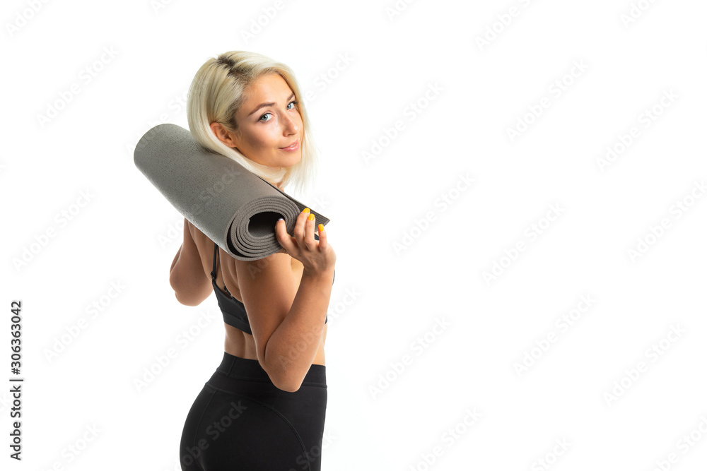 sporty blonde girl in uniform holds a mat behind her back isolated white background sporty blonde girl in uniform holds a mat behind her back isolated white background