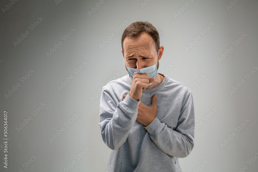 Can't breathe. Caucasian man wearing the respiratory protection mask against air pollution and dust particles exceed the safety limits. Healthcare, environmental, ecology concept. Allergy, headache. Can't breathe. Caucasian man wearing the respiratory protection mask against air pollution and dust particles exceed the safety limits. Healthcare, environmental, ecology concept. Allergy, headache.