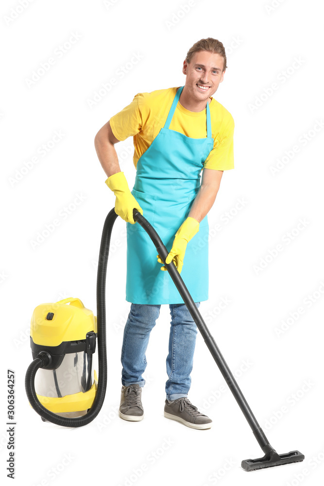 Male janitor with vacuum cleaner on white background