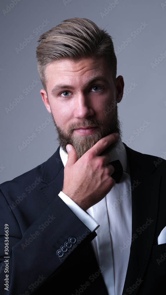Handsome caucasian man with beard in classic black suit. Handsome caucasian man with beard in classic black suit.