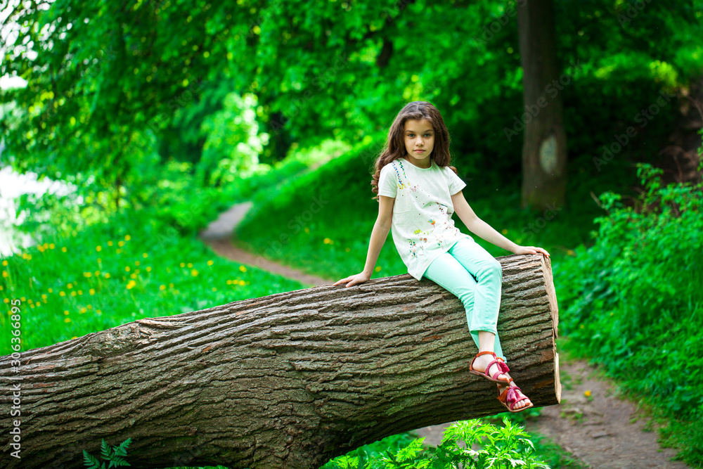 Little Girl on tree trunk Little Girl on tree trunk