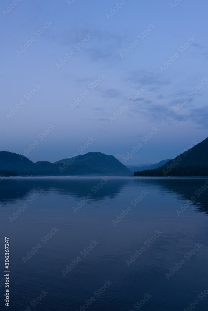 Lake Teletskoye in the mountains. In the evening you can see the hills and nature. Altai region