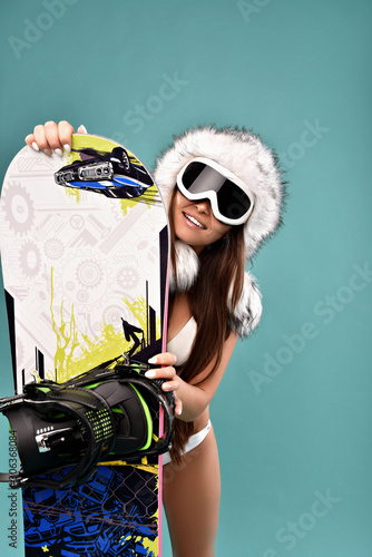 woman with a snowboard and a fur hat