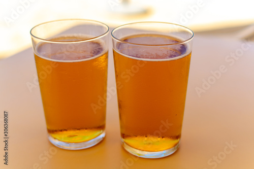 Cold amber color light spanish beer served in glass in outdoor cafe in sunny Andalusia, Spain
