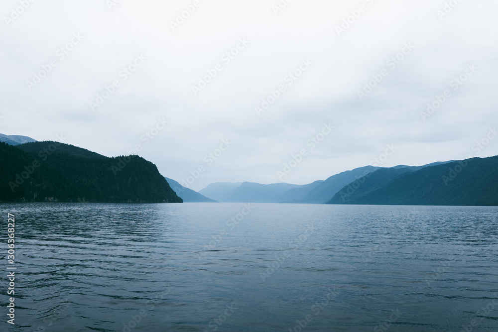 Lake Teletskoye in the mountains. In the evening you can see the hills and nature. Altai region