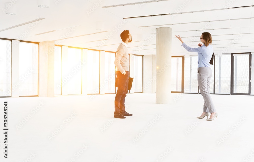 Professionals analyzing empty workspace in new office Professionals analyzing empty workspace in new office