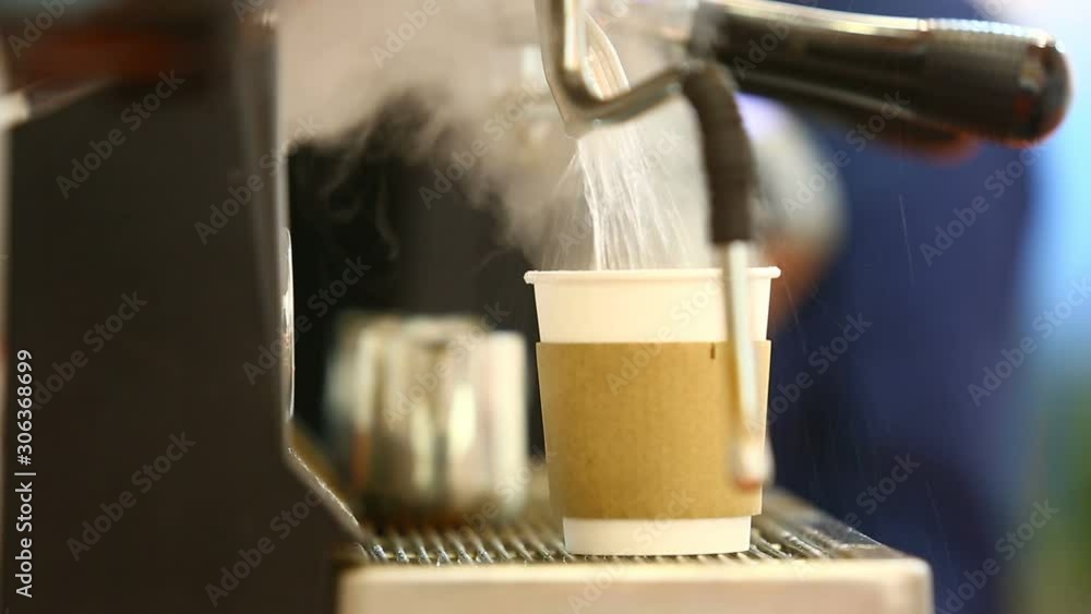 The Barista pours boiling water into a paper Cup The Barista pours boiling water into a paper Cup