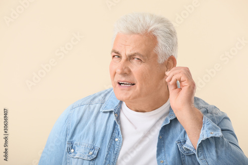 Mature man with hearing pro...