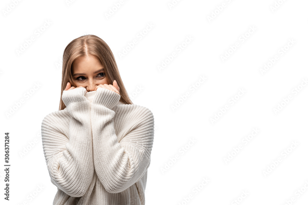 happy cold young woman in white sweater, isolated on white