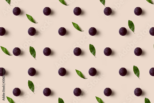 Grape pattern isolated on soft orange background. Fresh fruit.