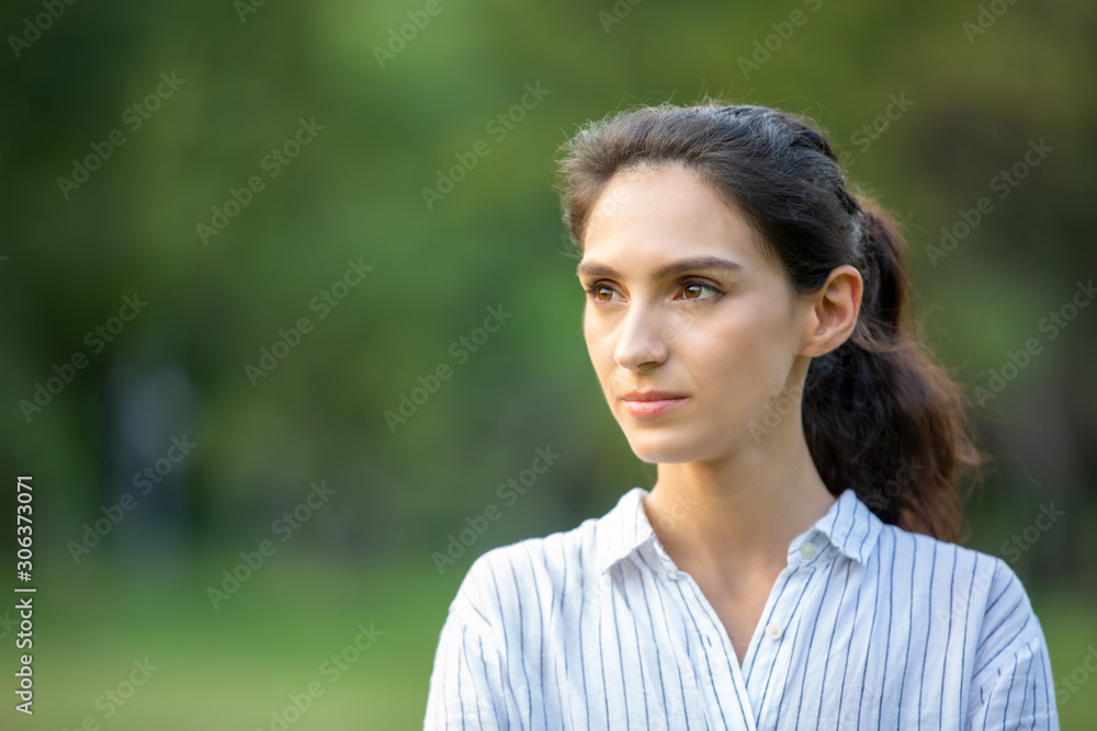side view of confident women standing with arm cross 