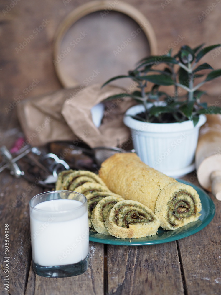 pastry roll on a green plate with ingredients on a brown background pastry roll on a green plate with ingredients on a brown background